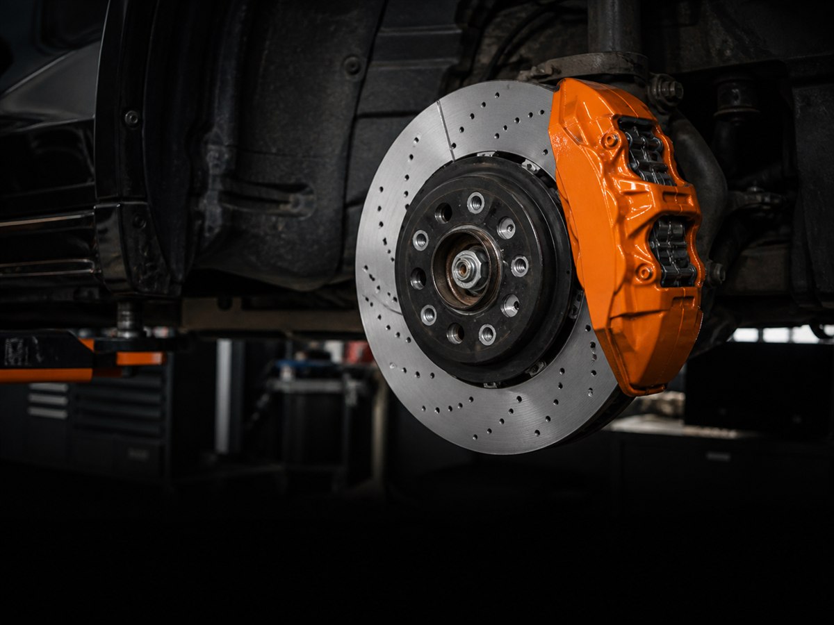 Performance brake disc and caliper in a professional workshop